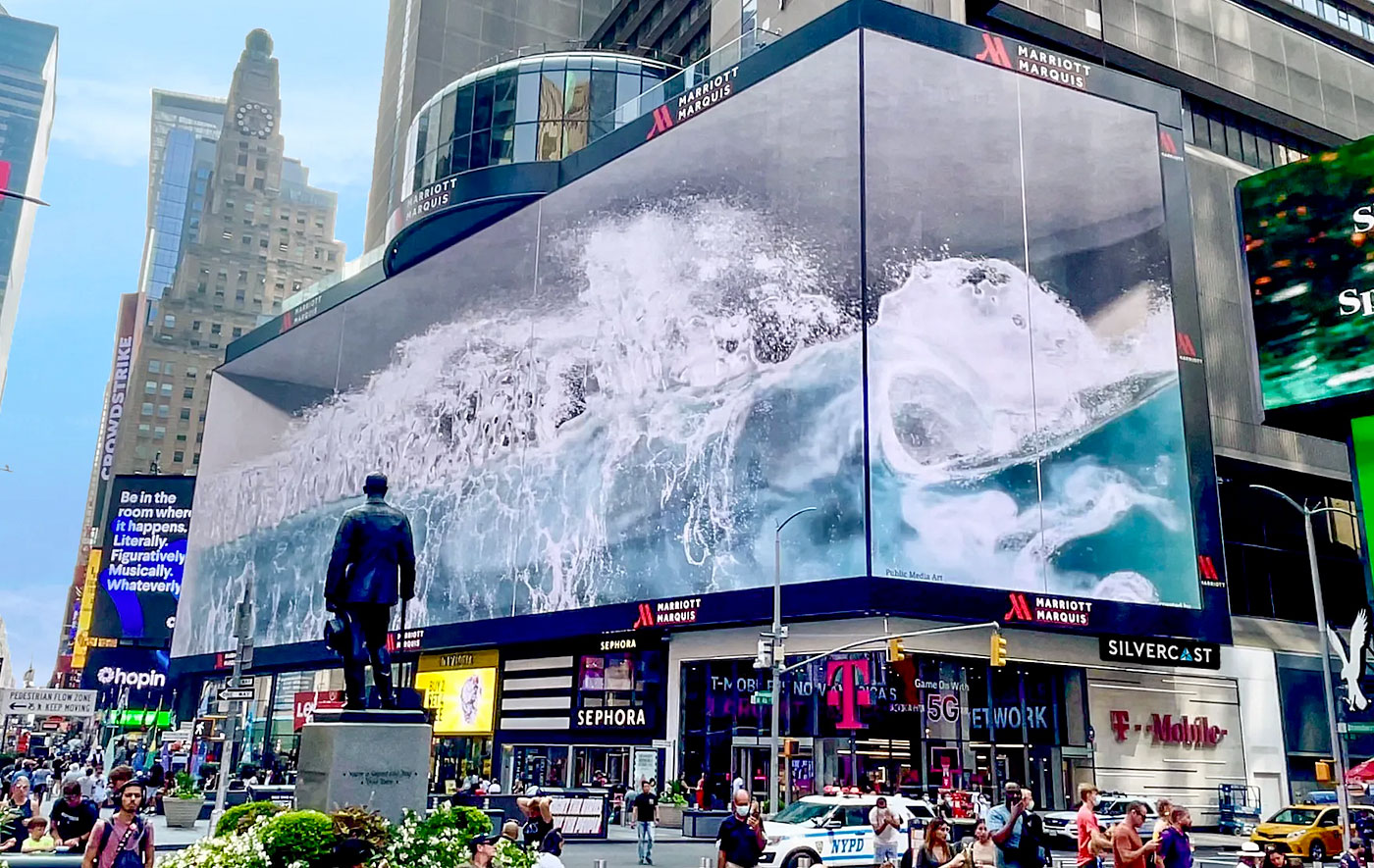 People filming a 3D anamorphic billboard in a city square as a car appears to burst out of the screen.