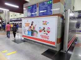 Advertising in Airport Road Metro station showcasing brand visibility through metro panels and digital screens