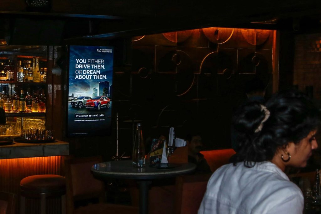 Mahindra Electric, Origin SUV, DOOH advertising, Tagtalk, Delhi NCR cafés, EV marketing, premium OOH, MyHoardings, lifestyle branding, digital screen campaign